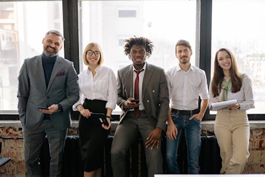 pexels-photo-7793115-7793115 A diverse group of professionals smiling and posing together in a modern office environment.